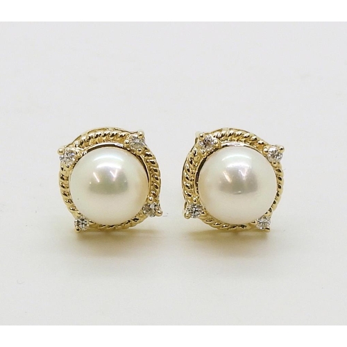 2798 - PEARL & DIAMOND EARRINGSmade in 18ct gold set with a pearl each approx 7.1mm, with the rope bord... 