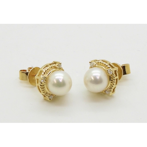 2798 - PEARL & DIAMOND EARRINGSmade in 18ct gold set with a pearl each approx 7.1mm, with the rope bord... 