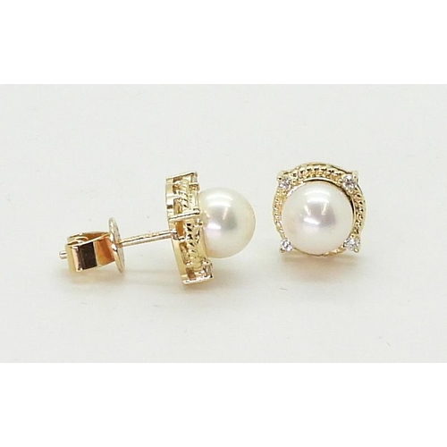 2798 - PEARL & DIAMOND EARRINGSmade in 18ct gold set with a pearl each approx 7.1mm, with the rope bord... 