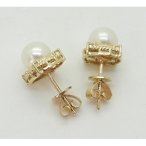 2798 - PEARL & DIAMOND EARRINGSmade in 18ct gold set with a pearl each approx 7.1mm, with the rope bord... 