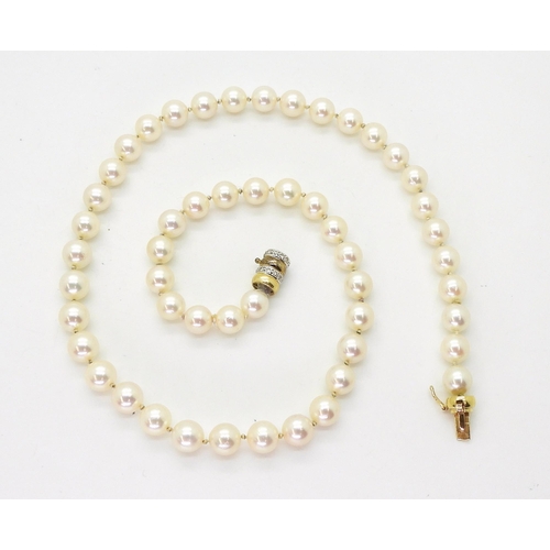 2801 - A STRING OF PEARLScreamy pink in colour, each pearl approx 7.2mm, length 47.5cm, with a diamond set ... 