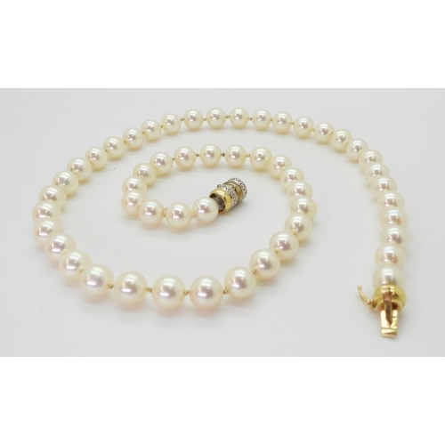 2801 - A STRING OF PEARLScreamy pink in colour, each pearl approx 7.2mm, length 47.5cm, with a diamond set ... 