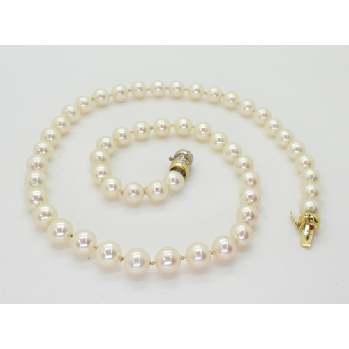 2801 - A STRING OF PEARLScreamy pink in colour, each pearl approx 7.2mm, length 47.5cm, with a diamond set ... 