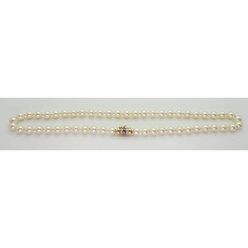 2801 - A STRING OF PEARLScreamy pink in colour, each pearl approx 7.2mm, length 47.5cm, with a diamond set ... 