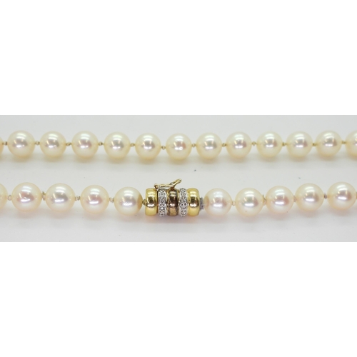 2801 - A STRING OF PEARLScreamy pink in colour, each pearl approx 7.2mm, length 47.5cm, with a diamond set ... 