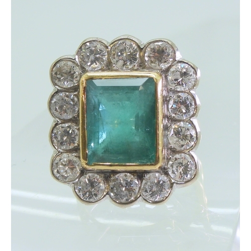 2805 - AN EMERALD & DIAMOND CLUSTER RINGthis substantial ring is set with a large step cut emerald with... 