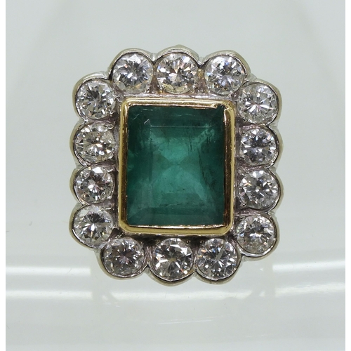 2805 - AN EMERALD & DIAMOND CLUSTER RINGthis substantial ring is set with a large step cut emerald with... 