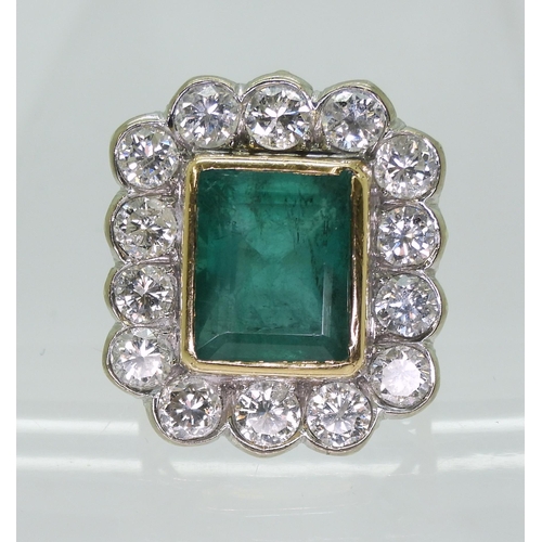 2805 - AN EMERALD & DIAMOND CLUSTER RINGthis substantial ring is set with a large step cut emerald with... 