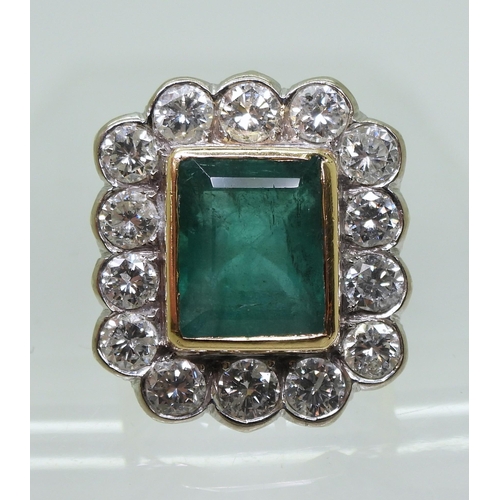 2805 - AN EMERALD & DIAMOND CLUSTER RINGthis substantial ring is set with a large step cut emerald with... 