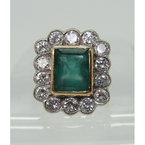 2805 - AN EMERALD & DIAMOND CLUSTER RINGthis substantial ring is set with a large step cut emerald with... 