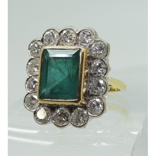 2805 - AN EMERALD & DIAMOND CLUSTER RINGthis substantial ring is set with a large step cut emerald with... 