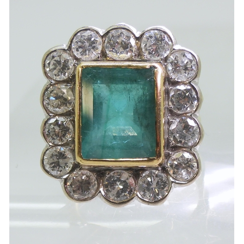 2805 - AN EMERALD & DIAMOND CLUSTER RINGthis substantial ring is set with a large step cut emerald with... 