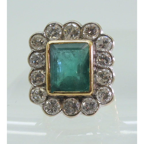 2805 - AN EMERALD & DIAMOND CLUSTER RINGthis substantial ring is set with a large step cut emerald with... 