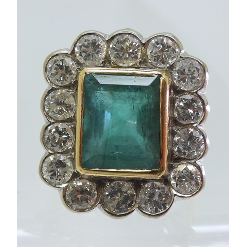 2805 - AN EMERALD & DIAMOND CLUSTER RINGthis substantial ring is set with a large step cut emerald with... 