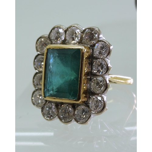 2805 - AN EMERALD & DIAMOND CLUSTER RINGthis substantial ring is set with a large step cut emerald with... 