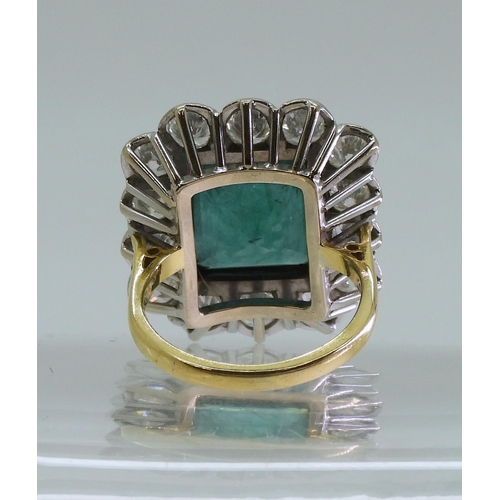 2805 - AN EMERALD & DIAMOND CLUSTER RINGthis substantial ring is set with a large step cut emerald with... 