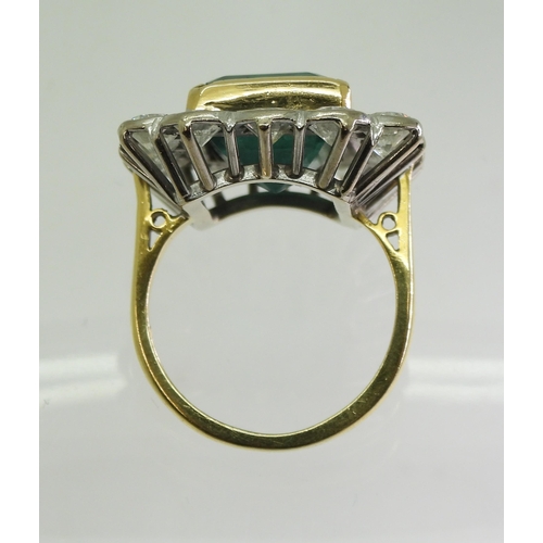 2805 - AN EMERALD & DIAMOND CLUSTER RINGthis substantial ring is set with a large step cut emerald with... 