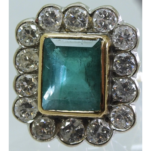 2805 - AN EMERALD & DIAMOND CLUSTER RINGthis substantial ring is set with a large step cut emerald with... 