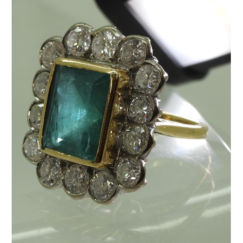 2805 - AN EMERALD & DIAMOND CLUSTER RINGthis substantial ring is set with a large step cut emerald with... 