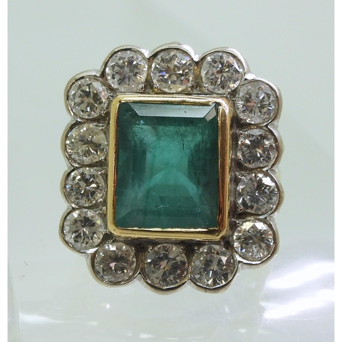 2805 - AN EMERALD & DIAMOND CLUSTER RINGthis substantial ring is set with a large step cut emerald with... 