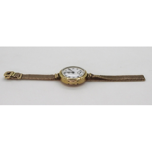 2913 - A LADIES VINTAGE ROLEXin 9ct gold, the white dial with subsidiary seconds dial blued steel hands, an... 