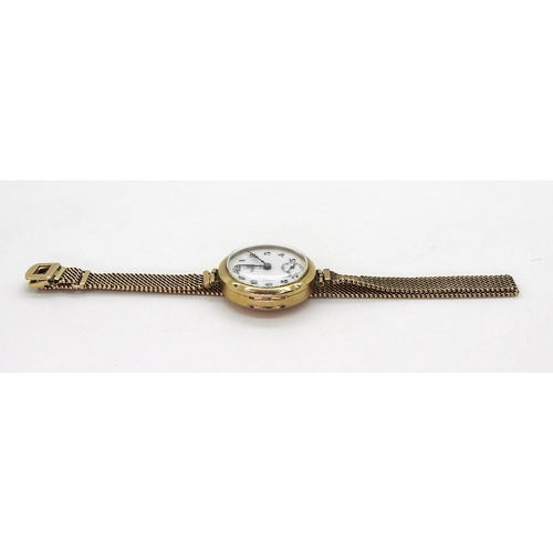 2913 - A LADIES VINTAGE ROLEXin 9ct gold, the white dial with subsidiary seconds dial blued steel hands, an... 