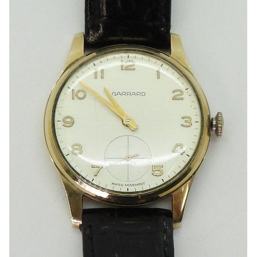 2929 - A 9CT GOLD GARRARD WATCHwith cream dial, subsidiary seconds dial, gold Arabic numerals and hands. Di... 