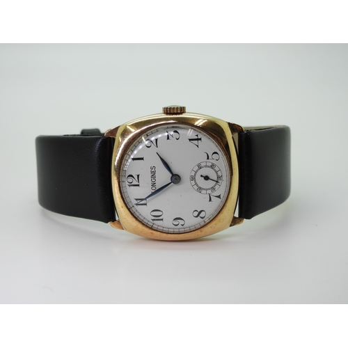 2933 - A 9CT LONGINES WATCHwith white enamel dial with  black roman numerals, subsidiary seconds dial and b... 