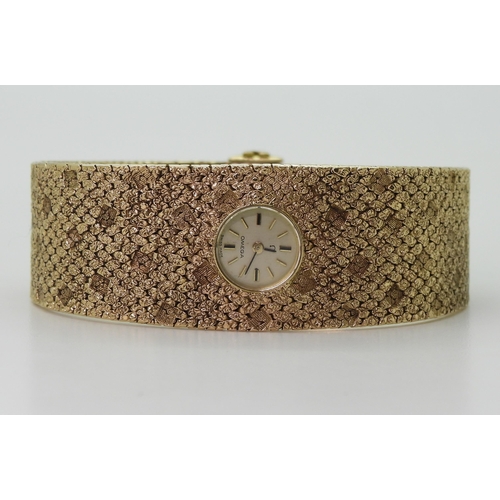 2939 - A LADIES RETRO OMEGAthe 9ct wide cuff style woven bracelet has all over texture, with a 1cm wide gol... 