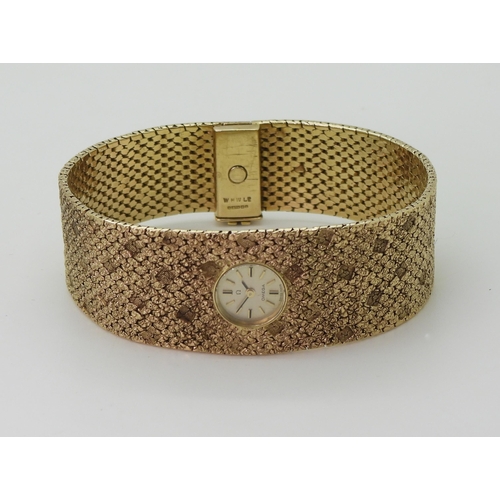 2939 - A LADIES RETRO OMEGAthe 9ct wide cuff style woven bracelet has all over texture, with a 1cm wide gol... 