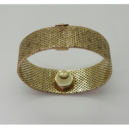 2939 - A LADIES RETRO OMEGAthe 9ct wide cuff style woven bracelet has all over texture, with a 1cm wide gol... 