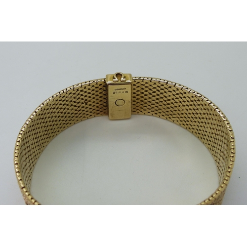 2939 - A LADIES RETRO OMEGAthe 9ct wide cuff style woven bracelet has all over texture, with a 1cm wide gol... 