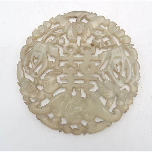 2332 - A CHINESE HARDSTONE PIERCED CIRCULAR DISC carved with a bat and calligraphy,7.5cm diameter and a Sat... 