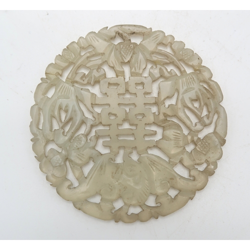 2332 - A CHINESE HARDSTONE PIERCED CIRCULAR DISC carved with a bat and calligraphy,7.5cm diameter and a Sat... 