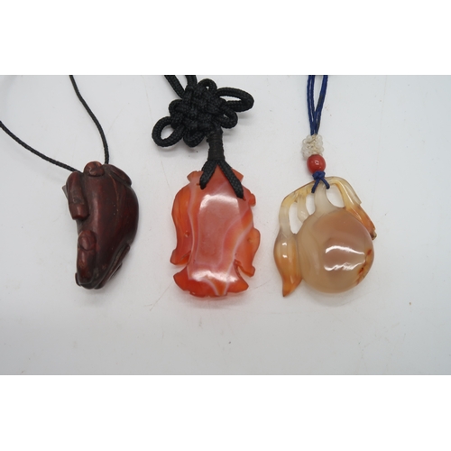 2330 - THREE CHINESE HARDSTONE PENDANT NECKLACESa fruit, 3.5cm long, figure, 4cm long and oxen, 4cm wide (3... 