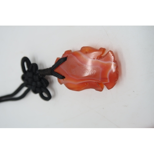 2330 - THREE CHINESE HARDSTONE PENDANT NECKLACESa fruit, 3.5cm long, figure, 4cm long and oxen, 4cm wide (3... 