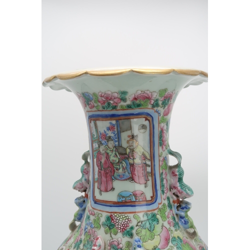 2327 - A LARGE CANTON BALUSTER VASE painted with panels of mandarins and courtiers on pavillions,flanked by... 