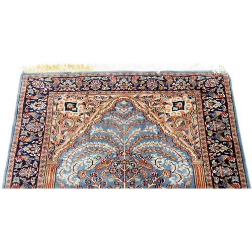 2140A - A BLUE GROUND PERSIAN TREE OF LIFE PATTERN RUG decorated with stylized animals within flower he... 