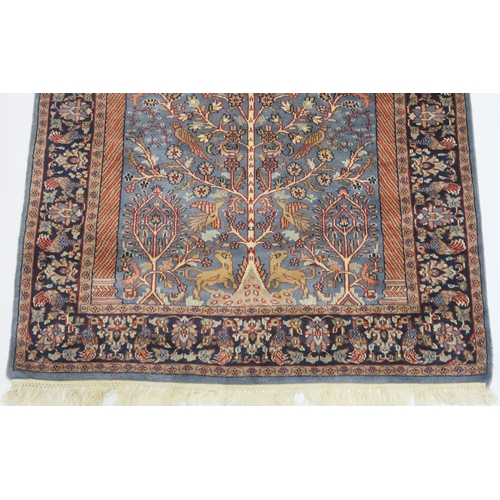 2140A - A BLUE GROUND PERSIAN TREE OF LIFE PATTERN RUG decorated with stylized animals within flower he... 