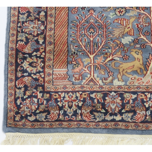 2140A - A BLUE GROUND PERSIAN TREE OF LIFE PATTERN RUG decorated with stylized animals within flower he... 