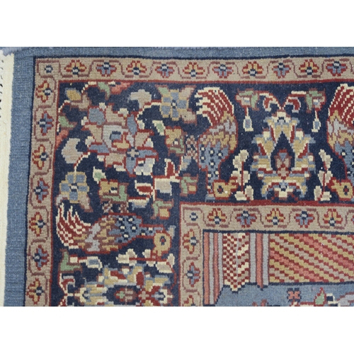 2140A - A BLUE GROUND PERSIAN TREE OF LIFE PATTERN RUG decorated with stylized animals within flower he... 