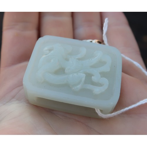 2328 - A CHINESE HARDSTONE PENDANT BROOCHcarved with calligraphy and in a white metal mount, 22.42 grams, 4... 