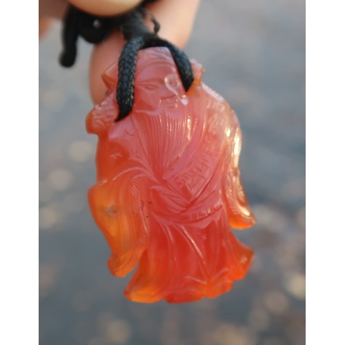 2330 - THREE CHINESE HARDSTONE PENDANT NECKLACESa fruit, 3.5cm long, figure, 4cm long and oxen, 4cm wide (3... 