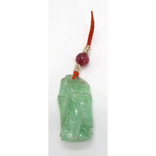 2331 - THREE CHINESE ROCK CRYSTAL PENDANTSone carved as a bamboo section,4.5cm high, a fruit, 4cm high and ... 