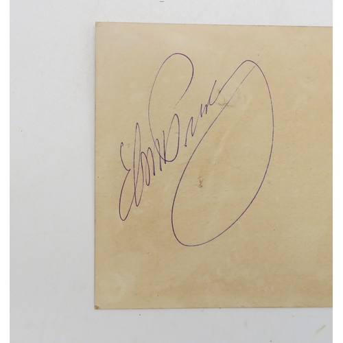 2630B - ELVIS PRESLEY: AN AUTOGRAPHSigned in blue ink upon a piece of yellowed card measuring approx. 15cm x... 