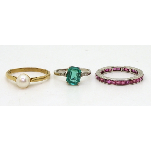 806 - A ruby full eternity ring, set with square cut rubies throughout, mounted in white metal with hand e... 