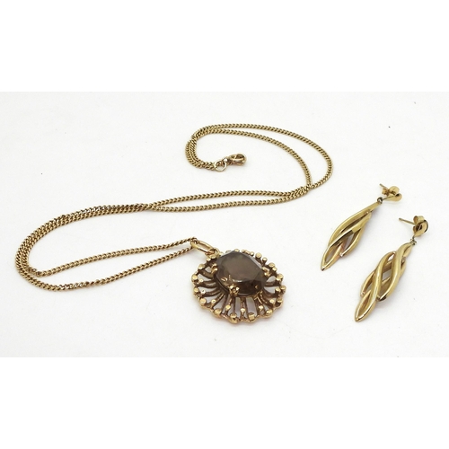 811 - A 9ct gold retro smoky quartz pendant and 50cm chain, weight 9.8gms together with a pair of 14k gold... 