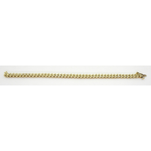 816 - A 14k gold diamond line bracelet, with 'S' shaped links and set with 2.20cts of brilliant cut diamon... 