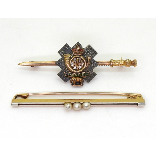 820 - A yellow and white metal Highland Light Infantry sweetheart brooch with enamel detail, bearing the m... 