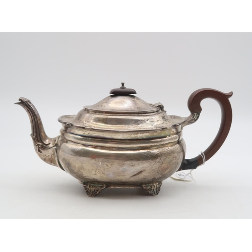 362 - A George V silver teapot, London 1928, of squat oval form, on four bracket feet, with a scrolling ri... 